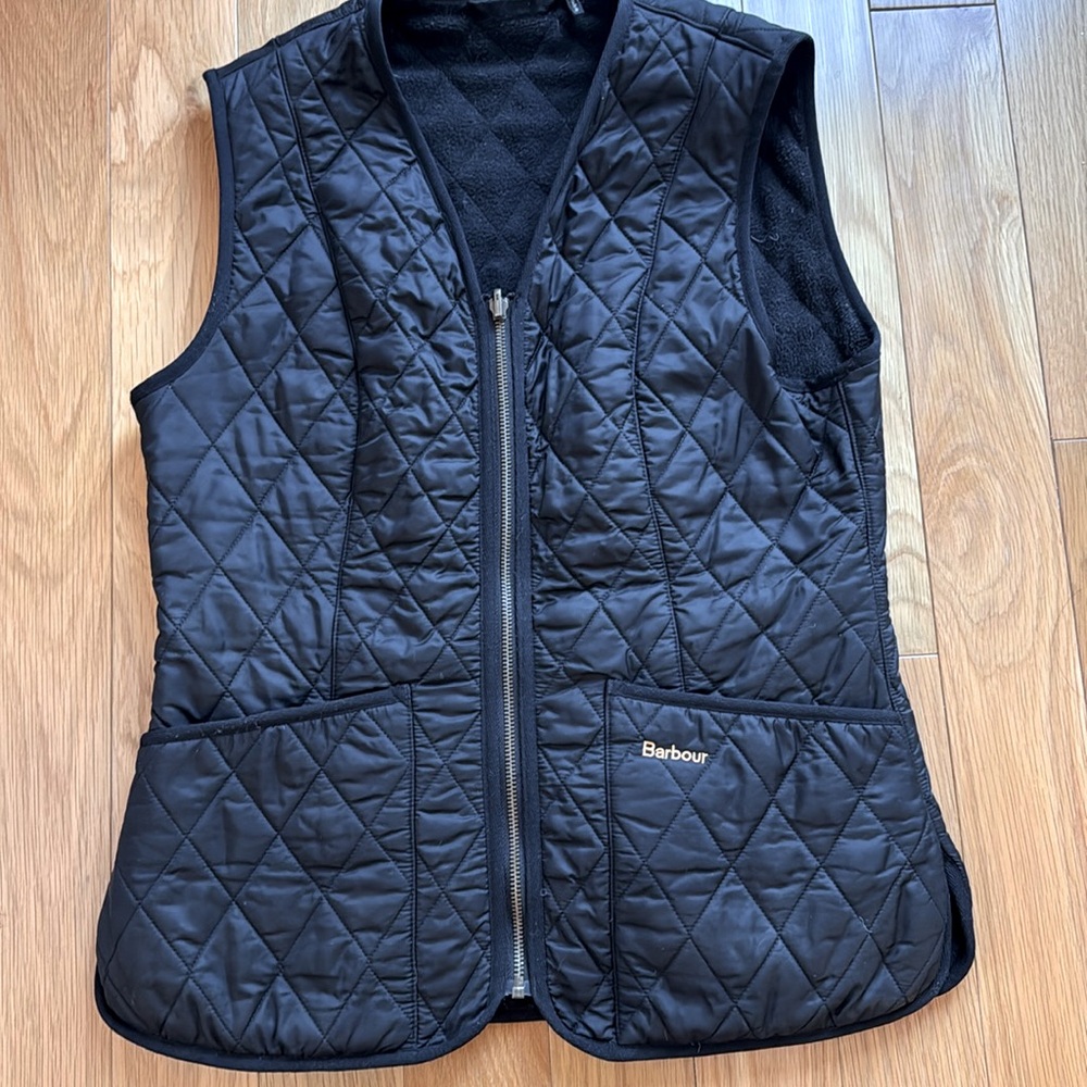 Classic Barbour quilted vest with cozy fleece lining.